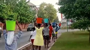 Students carrying buckets of water