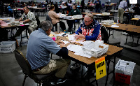 Electoral workers count votes during the 2024 U.S. presidential election