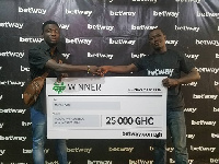 Michael Kyere being presented a dummy cheque