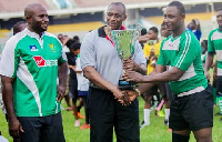 Ernest Hanson (middle) presenting a trophy to a Rugby player