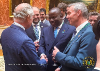 Abu Jinapor in a warm handshake with the British monarch