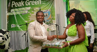 Mensah Seneadza (left), Country Manager, presenting a pack to a lucky winner