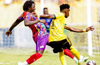 Hearts of Oak's Sulley Muntari tackles an opponent during a Ghana Premier League game