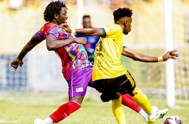 Hearts of Oak's Sulley Muntari tackles an opponent during a Ghana Premier League game