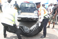 The body of the deceased being put in the police vehicle