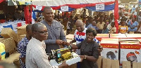 Dr. Nana Ayew Afriyie donates a sewing machine to one of the constituents