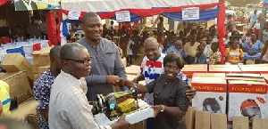 Dr. Nana Ayew Afriyie donates a sewing machine to one of the constituents