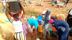 Some women in the North East Region getting water from a stream