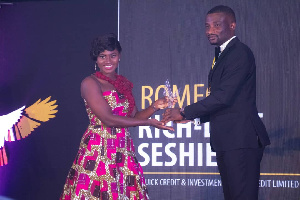 CEO of Quick Credit and Investment Micro Credit Limited, Romeo Rich-love Seshie receiving his award