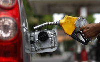 Attendant fueling a car | File photo