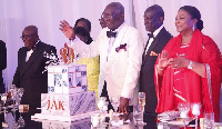 Kufuor being assisted by his children and President Akufo-Addo to cut the 80th birthday cake