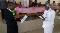 Alfred Kofi Wokanya (in white) being sworn into office