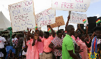 Students brandishing placards in praise of Free SHS