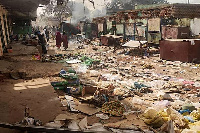 People walk among scattered objects in the market of el-Geneina, the capital of West Darfur