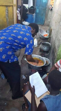 Alfred Okoe Vanderpuije seen cooking soup at the Ablekuma South