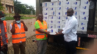 Kwame Adu-Darkwa presenting the items to DCE for Asuogyaman