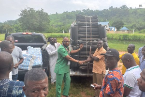 Frank Selorm Ankutse (in green) making the donation to the school