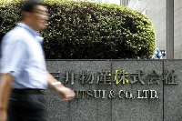 A man walks past the headquarters of Japanese general trading company Mitsui & Co., Ltd. in Tokyo