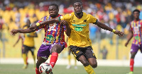 Hearts of Oak defender, Dennis Korsah(L) battles Kotoko forward, George Mfegue(R)