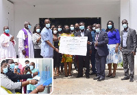 Dr. Philip Bannor, Registrar of HEFRA presenting the certificate to Dr. Elikem Tamaklo