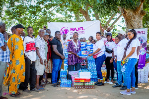 Volunteers of the foundation presenting items to some community memberr