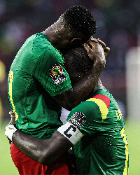 Cameroon player Collins Fai  hugs captain, Vincent Aboubakar