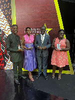 Executives captured in a photo with the awards