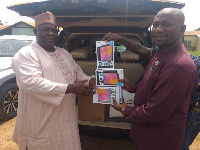 Alhaji Limuna Mohammed Muniru presenting the tablets to the NDC communication team