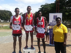 The medal winners with their certificates, looking on is a member of Sports Directorate