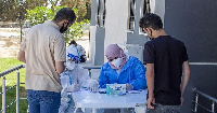 People lined up outside a COVID-19 vaccination center in Tripoli