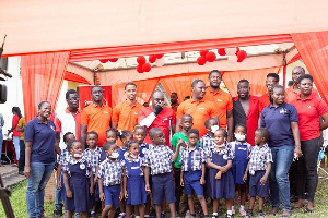 Staff and executives Vodafone Ghana Foundation with some pupils