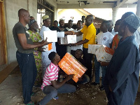 Mr. Boateng giving the items to the the representatives of the community