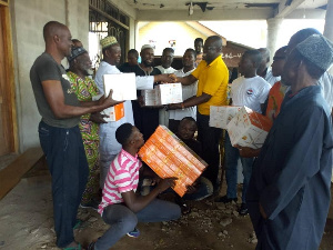 Mr. Boateng giving the items to the the representatives of the community