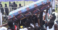 NDC supporters carrying a coffin with Nana Addo's posters on it