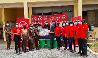 Absa Bank employees presenting the items to officials of the Senior Correctional Centre