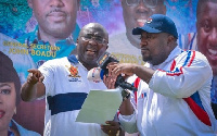 Dr Mahamudu Bawumia (L) speaking into microphone held by NPP's National Youth Organiser