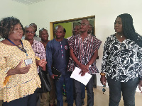 Tangoba Abayage interacting with management and staff of the Paga District Health Centre