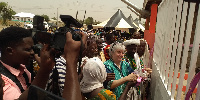 Ambassador Sullivan flanked by community members cutting the ribbon to open the facility