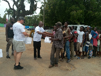 Some staff of PassionAir distributing packs of food to needy and vulnerable persons