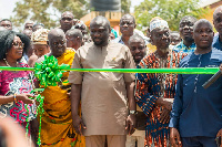 Paul Amaning flanked with the guest speaker and the chiefs cutting the tape