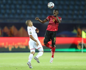 ani Massunguna of Angola challenged by Wahbi Khazri of Tunisia