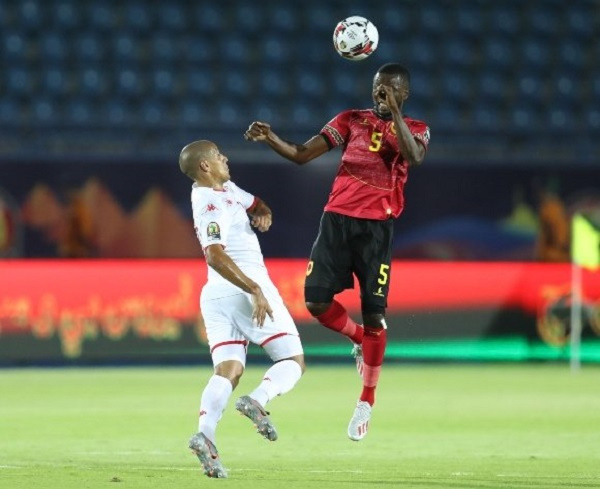 ani Massunguna of Angola challenged by Wahbi Khazri of Tunisia