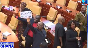 MP James Agalga holding the placard in parliament