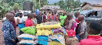 Kofi Arko Nokoe presents the items to the flood victims