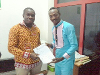 Abraham Kofi Davies aka Salinko with a GN Bank representative