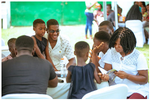 Sharaf Mahama reading with some of the children