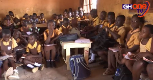 Some pupils who do not have desks, make themselves comfortable on floor to study