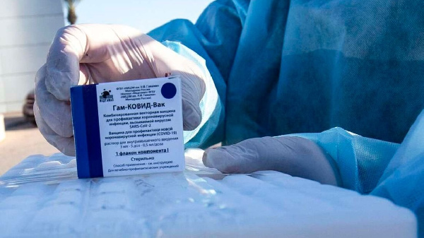 A health worker carries a box of Russian-made Sputnik V vaccine doses. PHOTO | SAID KHATIB | AFP