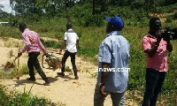 The Minister [in blue cap] ensuring the seized items are taken away