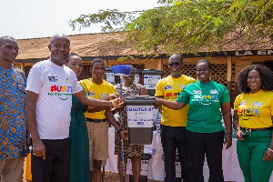 The Human Resources Manager of Vivo Energy Ghana, Mercy Amoah(right) presenting cleaning items